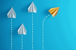 One of the four paper airplanes takes a different flight path.