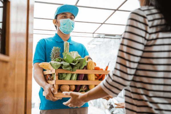 Man giving produce to someone