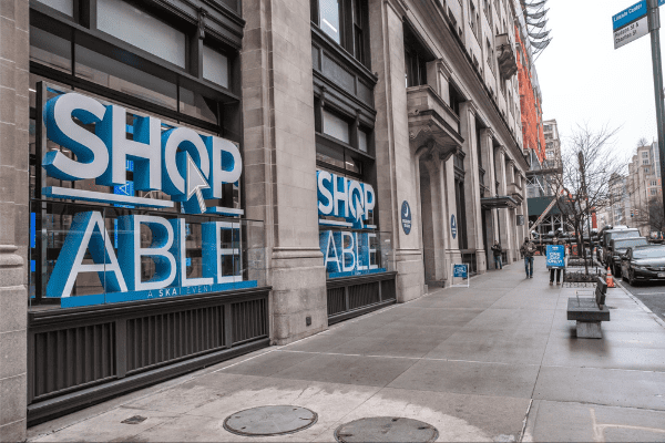 ShopAble event 2022 signs hang on the outside of a New York City building.