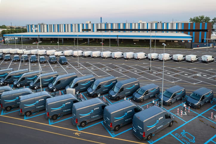 Top view of Amazon Prime electric delivery vans, parked at the logistics hub of Amazon.