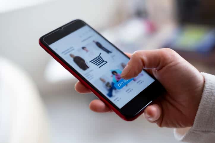 A person is exposed to retail media while shopping on their mobile device.