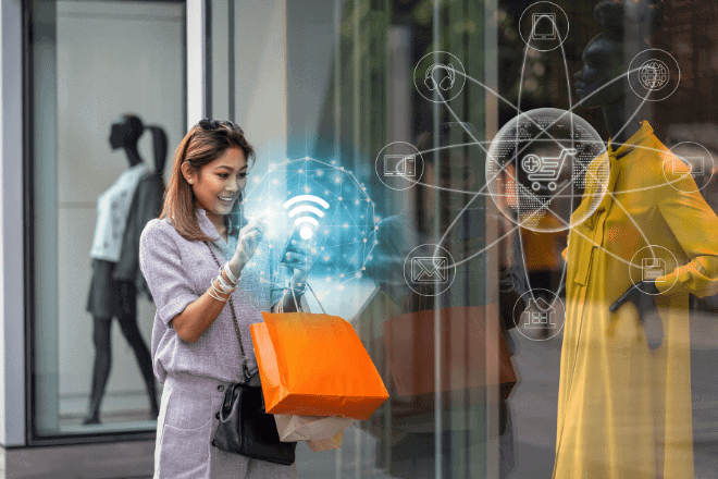A woman holding shopping bags uses her smartphone outside a store. Digital shopping and internet icons are overlaid, representing online shopping or smart retail technology and highlighting the importance of omnichannel experiences in modern retail. Mannequins in the display window are visible.